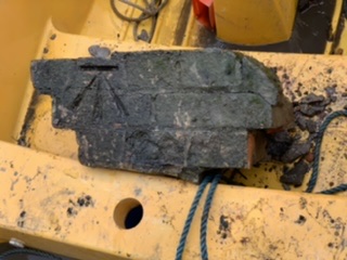Brick locator photo being recovered from canal